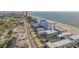 Scenic aerial view of a coastal property with ample parking and beach access at 3615 S Atlantic Ave # 211, Daytona Beach, FL 32118