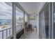 Screened balcony with seating, offering outdoor living space with neighborhood views at 3615 S Atlantic Ave # 211, Daytona Beach, FL 32118