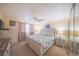 Bright bedroom features neutral walls, ceiling fan, furnishings and carpeted floors at 3615 S Atlantic Ave # 211, Daytona Beach, FL 32118