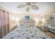 Well-lit bedroom features neutral walls, ceiling fan, furnishings, and a mirror closet at 3615 S Atlantic Ave # 211, Daytona Beach, FL 32118