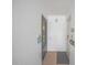 Hallway with the front door leading to unit 212, and a storm door at 3615 S Atlantic Ave # 211, Daytona Beach, FL 32118