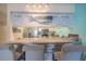 Kitchen with a bar, white cabinetry, and stainless steel appliances at 3615 S Atlantic Ave # 211, Daytona Beach, FL 32118