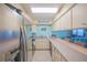 Kitchen with white cabinetry and stainless steel refrigerator at 3615 S Atlantic Ave # 211, Daytona Beach, FL 32118