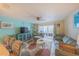 Living room area with view to the balcony, access to the kitchen and bar seats at 3615 S Atlantic Ave # 211, Daytona Beach, FL 32118