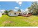 Expansive backyard with a well-maintained lawn and a wooden deck, perfect for outdoor activities and relaxation at 3626 Donna St, Port Orange, FL 32129