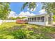 Lush backyard featuring a screened-in porch and a wooden deck, creating a relaxing outdoor oasis for leisure at 3626 Donna St, Port Orange, FL 32129