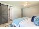Bedroom with hardwood floors and large windows, and a sliding door to an ensuite bathroom at 3626 Donna St, Port Orange, FL 32129