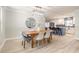 Open-concept dining area with modern lighting, wood floors, and seamless flow to kitchen at 3626 Donna St, Port Orange, FL 32129