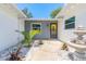 Charming courtyard with elegant landscaping, a decorative fountain, and a bright, inviting entrance at 3626 Donna St, Port Orange, FL 32129