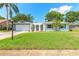 Charming single-story home with a well-manicured lawn, mature trees, and a welcoming entrance at 3626 Donna St, Port Orange, FL 32129