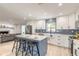Modern kitchen features stainless steel appliances, white cabinets, blue backsplash, and a kitchen island with seating at 3626 Donna St, Port Orange, FL 32129
