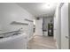 Bright laundry room with modern appliances, and white storage shelves at 3626 Donna St, Port Orange, FL 32129