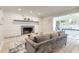 Living room features a brick fireplace, mantel, grey sofa, light-colored floors, and a window-filled alcove at 3626 Donna St, Port Orange, FL 32129