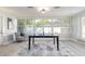 Sun room with ping pong table features ample lighting from the windows and a door to the outside at 3626 Donna St, Port Orange, FL 32129