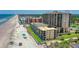 Stunning aerial view of a beachside resort with a pool, tennis court and direct beach access at 4139 S Atlantic Ave # B508, New Smyrna Beach, FL 32169