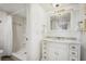 This bathroom features a vanity with marble countertop and a shower with glass door at 4139 S Atlantic Ave # B508, New Smyrna Beach, FL 32169