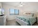 This bedroom has a light color palette, ceiling fan, and large windows at 4139 S Atlantic Ave # B508, New Smyrna Beach, FL 32169