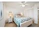 This bright bedroom features a large bed, ceiling fan, and ensuite bath at 4139 S Atlantic Ave # B508, New Smyrna Beach, FL 32169