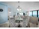 Bright dining area with a glass table, seating for six, and coastal views at 4139 S Atlantic Ave # B508, New Smyrna Beach, FL 32169