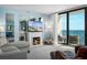 Inviting living room featuring a fireplace, ocean views, and comfortable seating at 4139 S Atlantic Ave # B508, New Smyrna Beach, FL 32169