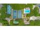 Aerial view of community amenities including tennis courts and a pool, all surrounded by lush greenery at 4403 Sea Mist Dr # 109, New Smyrna Beach, FL 32169