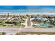 Aerial view of beach community, showcasing homes, lush landscaping, roads, and beachfront access to the ocean at 4403 Sea Mist Dr # 109, New Smyrna Beach, FL 32169