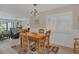Dining room featuring a wooden table with seating for four, adjacent to the living area at 4403 Sea Mist Dr # 109, New Smyrna Beach, FL 32169