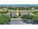 Coastal condo complex featuring lush landscaping, ample parking, and a partial ocean view at 4403 Sea Mist Dr # 109, New Smyrna Beach, FL 32169