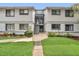 Inviting two-story condo building featuring well-maintained landscaping and easy access to upper-level units at 4403 Sea Mist Dr # 109, New Smyrna Beach, FL 32169