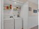Efficient laundry room with a washer, dryer, and shelving for storage, making laundry tasks convenient at 4403 Sea Mist Dr # 109, New Smyrna Beach, FL 32169