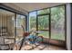Enclosed patio, featuring a bicycle, offering a cozy outdoor living space with a view of the lush surroundings at 4403 Sea Mist Dr # 109, New Smyrna Beach, FL 32169