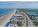 Stunning aerial shot of beachfront condos with the ocean and nearby towns at 4555 S Atlantic Ave # 4405, Ponce Inlet, FL 32127