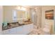 Stylish bathroom features a unique stone sink, granite countertop, and walk-in glass shower at 4555 S Atlantic Ave # 4405, Ponce Inlet, FL 32127