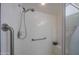 Walk-in shower featuring white tiling, and a safety bar at 4555 S Atlantic Ave # 4405, Ponce Inlet, FL 32127