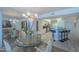 A view of the dining room with modern chandelier lighting, with the kitchen in the background at 4555 S Atlantic Ave # 4405, Ponce Inlet, FL 32127