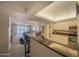 A kitchen breakfast bar with seating overlooks the living and dining rooms and has a marble countertop at 4555 S Atlantic Ave # 4405, Ponce Inlet, FL 32127