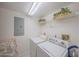 A dedicated laundry space with washer, dryer, and shelving for storage and organization at 4555 S Atlantic Ave # 4405, Ponce Inlet, FL 32127