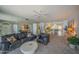 A bright, open living room features neutral colors, a ceiling fan, and a large mirror feature wall at 4555 S Atlantic Ave # 4405, Ponce Inlet, FL 32127
