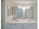 Elegant bathroom features double sinks, under-cabinet storage and large mirrors at 4575 S Atlantic Ave # 6607, Ponce Inlet, FL 32127