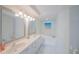 Bright bathroom features double sinks, a soaking tub, and a large mirror at 4575 S Atlantic Ave # 6607, Ponce Inlet, FL 32127