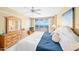 Bedroom featuring ocean views, a ceiling fan, and a wooden dresser at 4575 S Atlantic Ave # 6607, Ponce Inlet, FL 32127