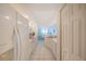 Spacious, well-lit kitchen featuring white appliances and tile flooring with living area view at 4575 S Atlantic Ave # 6607, Ponce Inlet, FL 32127