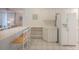 Kitchen with white cabinets and bar seating flows into the living area at 4575 S Atlantic Ave # 6607, Ponce Inlet, FL 32127