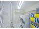 Convenient laundry room with washer, dryer, and storage shelves at 4575 S Atlantic Ave # 6607, Ponce Inlet, FL 32127