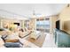 Bright living room featuring a ceiling fan, tile flooring, comfortable seating, and an ocean view balcony at 4575 S Atlantic Ave # 6607, Ponce Inlet, FL 32127