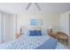 Cozy main bedroom with ceiling fan, ocean-themed art, and ample natural light at 4575 S Atlantic Ave # 6607, Ponce Inlet, FL 32127