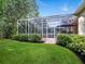 Lush backyard with screened in porch and private pool offers the perfect space for outdoor relaxation and fun at 461 Luna Bella Ln, New Smyrna Beach, FL 32168