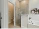 Bathroom featuring tiled shower, soaking tub, and private toilet area at 461 Luna Bella Ln, New Smyrna Beach, FL 32168