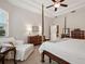 Spacious bedroom with ceiling fan, tray ceiling, and wood furniture at 461 Luna Bella Ln, New Smyrna Beach, FL 32168