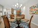 Dining room area with a glass table and stylish chairs, adjacent to the kitchen at 461 Luna Bella Ln, New Smyrna Beach, FL 32168